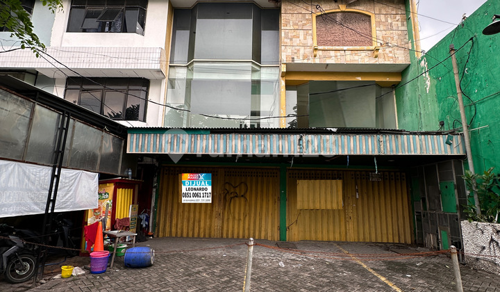 TWO ADJACENT STRATEGIC SHOPHOUSES IN NGAGEL JAYA SELATAN, 9X25 METERS WIDE, FACING SOUTH WITH SPACIOUS PARKING.